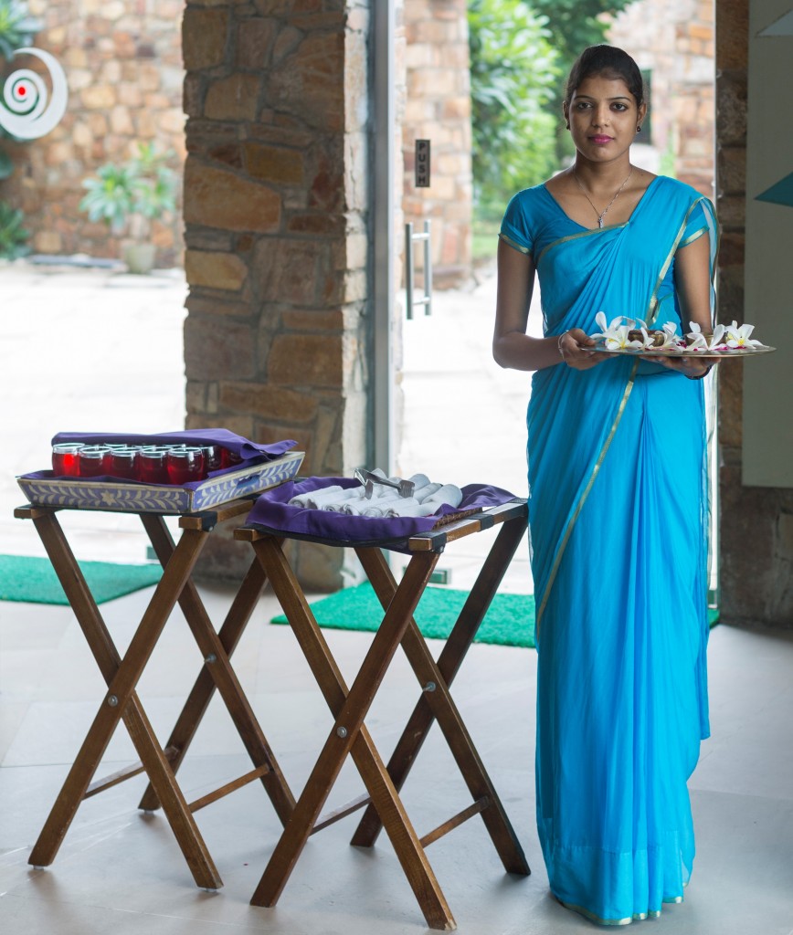 A Sari clad guest welcome representative awaits arrival of guests.